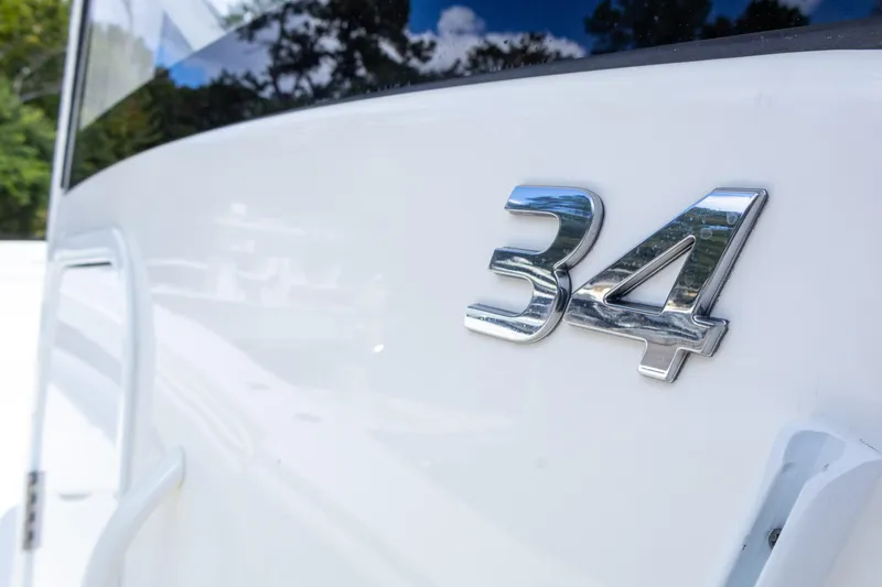 Slide: The Image of Close-up of 2023 Regulator 34 boat model emblem on white surface. - 17