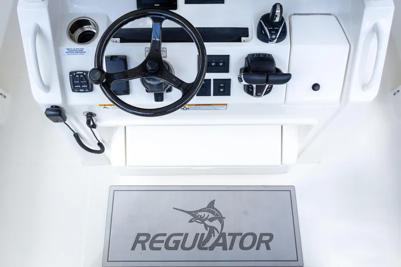 Slide: The Image of Regulator 34 boat helm with steering wheel and controls, 2023 model. - 18