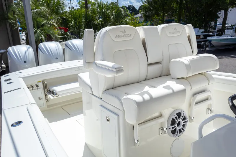 Slide: The Image of 2023 Regulator 34 boat with white seating and triple outboard engines. - 19