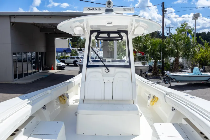Slide: The Image of 2023 Regulator 34 boat with center console and seating, displayed outdoors. - 20