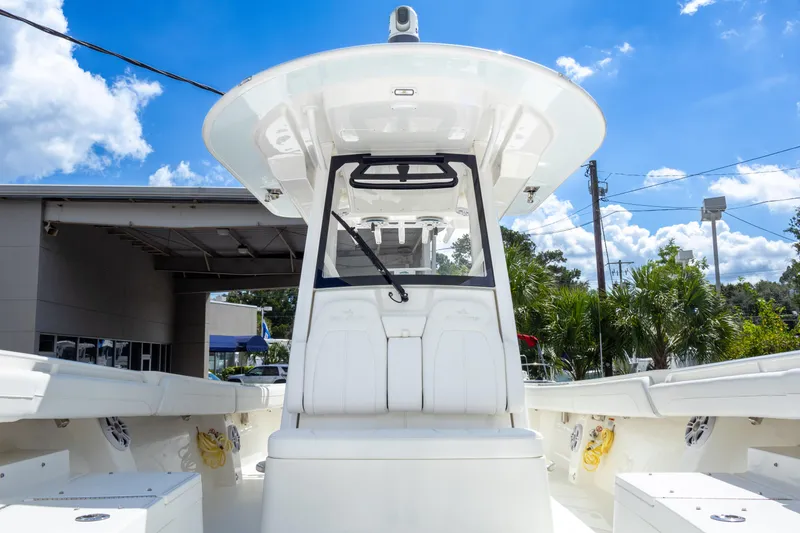 Slide: The Image of 2023 Regulator 34 boat, center console, white interior, sunny day, outdoor display. - 21