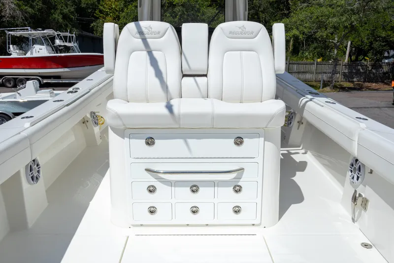 Slide: The Image of 2023 Regulator 34 boat with white seating and storage drawers. - 26