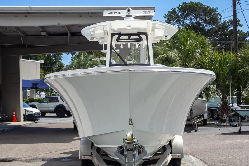 Slide: The Image of 2023 Regulator 34 boat on trailer, front view, parked outdoors. - 3