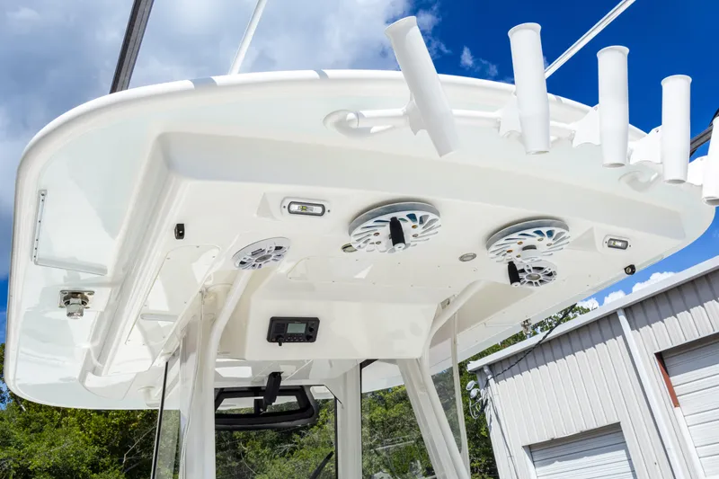Slide: The Image of 2023 Regulator 34 boat with speakers and rod holders under the canopy. - 33