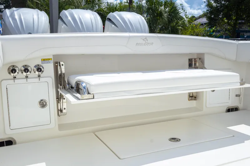 Slide: The Image of 2023 Regulator 34 boat with foldable bench seat and storage compartments. - 34