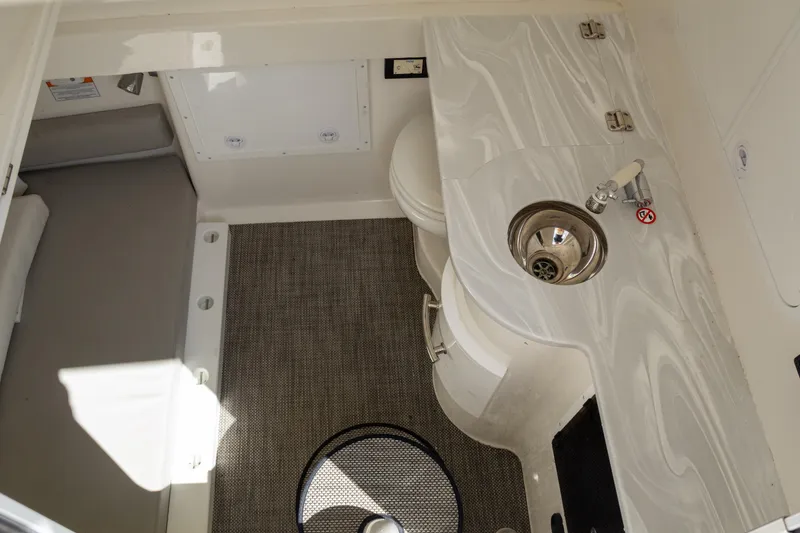 Slide: The Image of 2023 Regulator 34 boat interior with sink and carpeted flooring. - 35