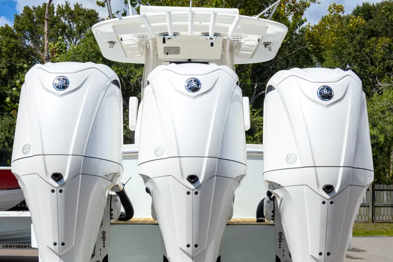 Slide: The Image of 2023 Regulator 34 boat with triple Yamaha outboard engines, rear view. - 7