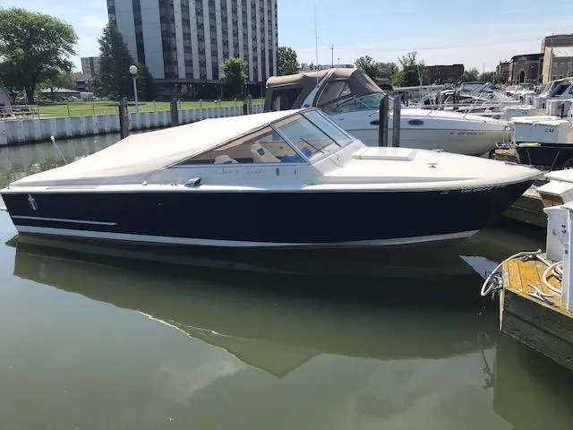 Slide: The Image of 1970 Chris-Craft 25 Lancer boat docked in a marina, with a sleek design. - 1