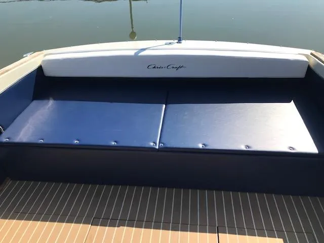 Slide: The Image of 1970 Chris-Craft 25 Lancer boat interior with blue seating and wooden deck. - 11