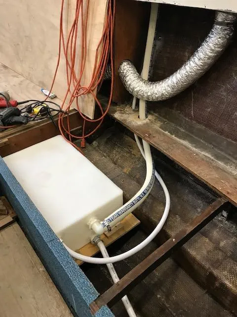 Slide: The Image of 1970 Chris-Craft 25 Lancer interior showing plumbing and wiring components. - 17