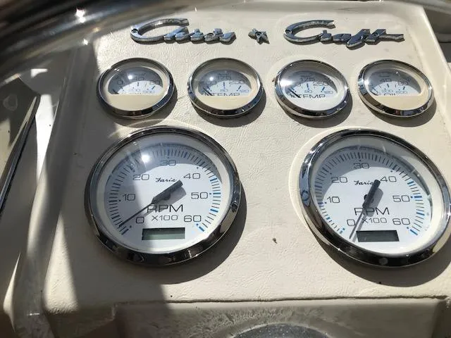 Slide: The Image of Dashboard of a 1970 Chris-Craft 25 Lancer boat with gauges and logo. - 8