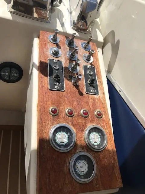 Slide: The Image of 1970 Chris-Craft 25 Lancer boat dashboard with gauges and switches. - 9