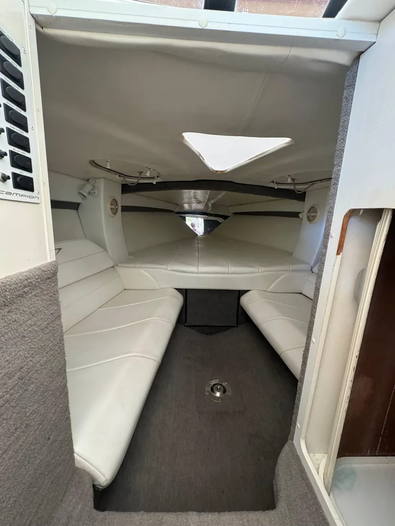 Slide: The Image of Interior of a 1997 Campion Chase 910 ZRI boat with white seating. - 10