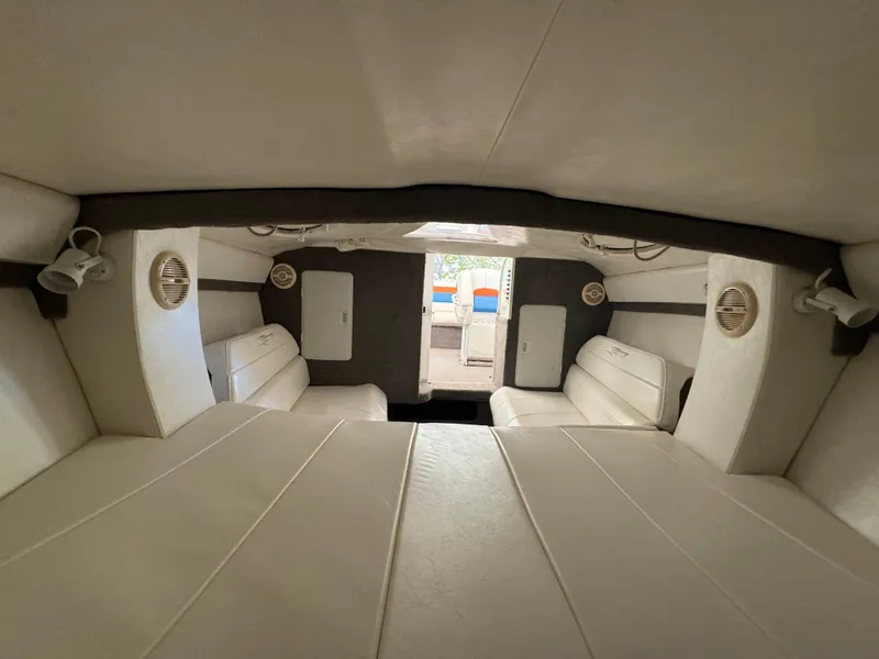 Slide: The Image of Interior of 1997 Campion Chase 910 ZRI boat, featuring white seating and speakers. - 11