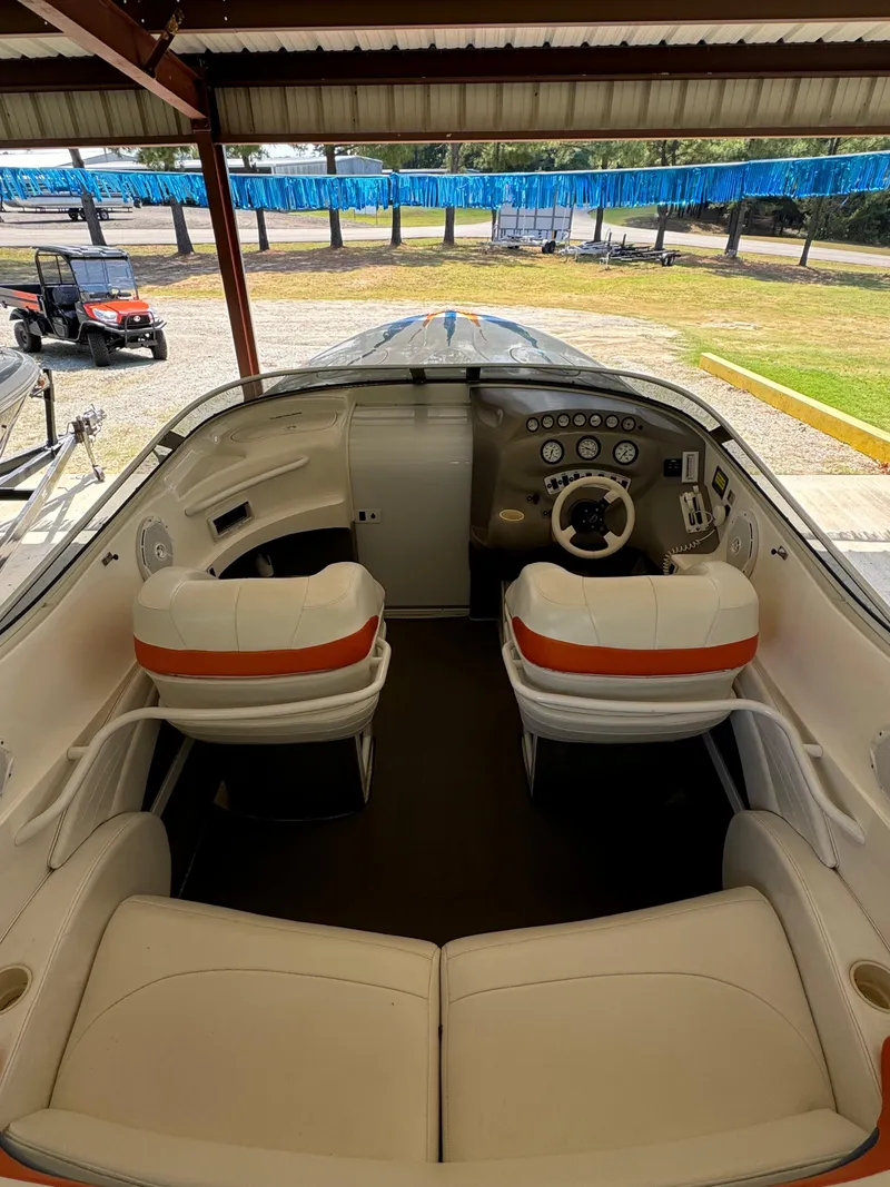 Slide: The Image of Interior of a 1997 Campion Chase 910 ZRI boat with white and orange seating. - 12