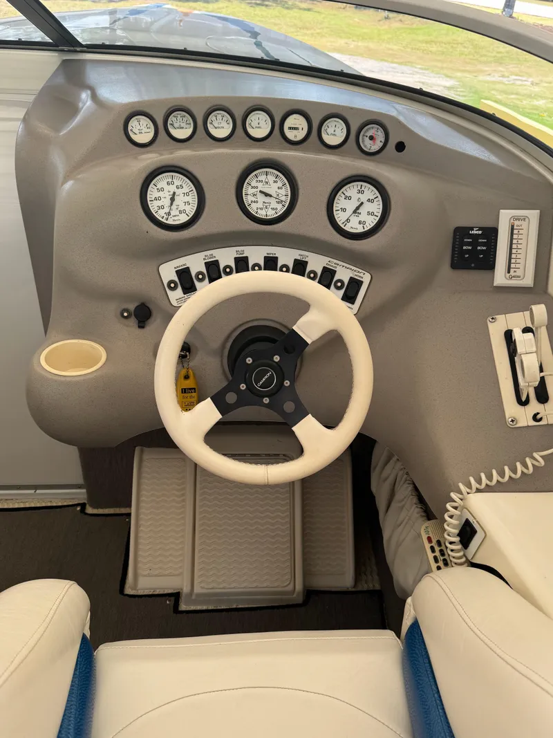Slide: The Image of Dashboard of a 1997 Campion Chase 910 ZRI boat with steering wheel and gauges. - 14