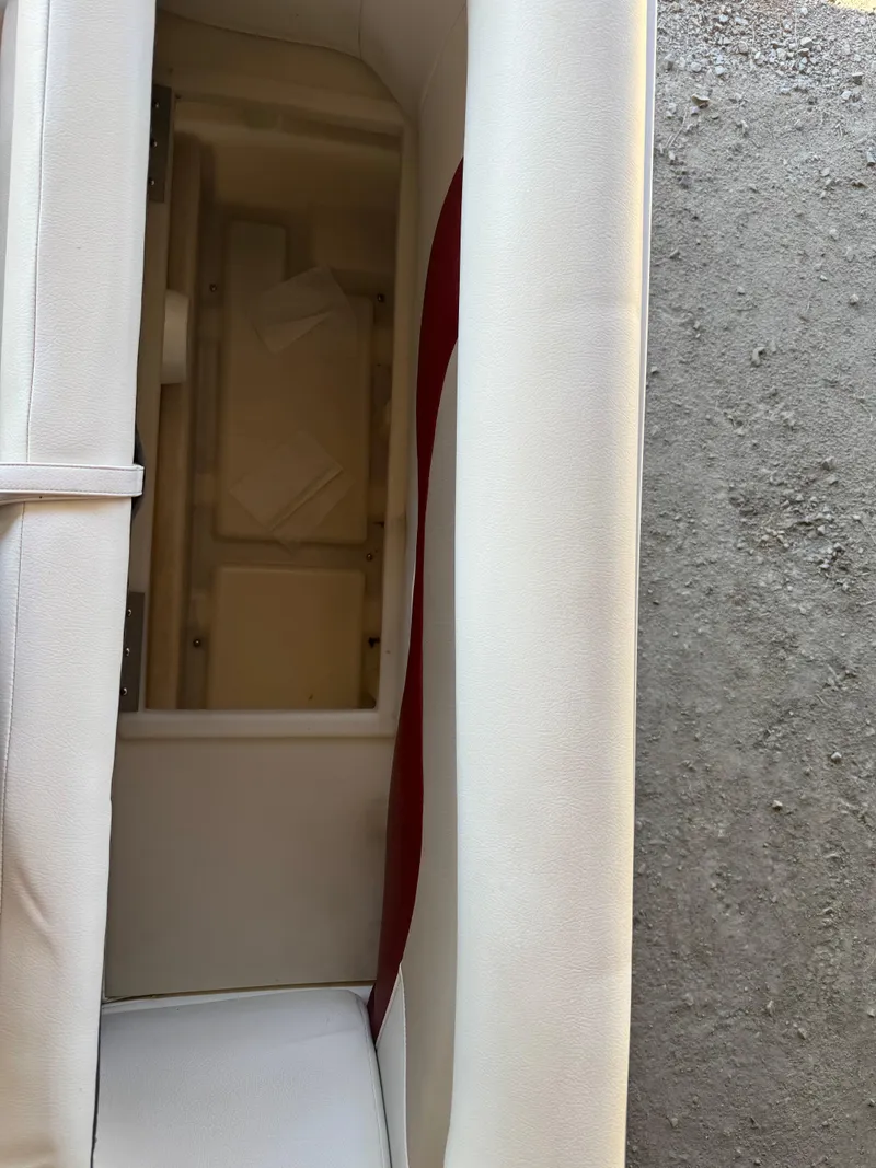 Slide: The Image of 2015 Hurricane Fun Deck 196 boat interior storage compartment with white and red upholstery. - 12