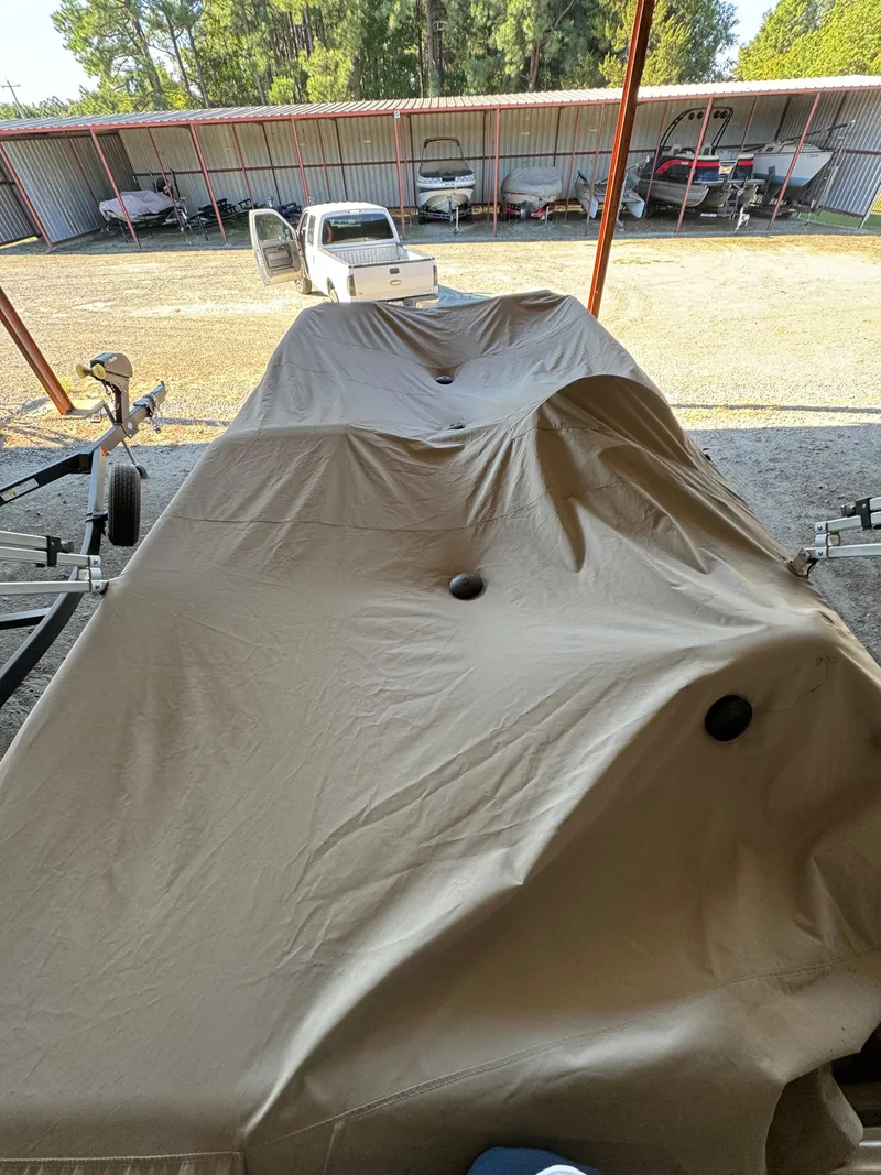 Slide: The Image of Covered 2015 Hurricane Fun Deck 196 boat on trailer in storage facility. - 14