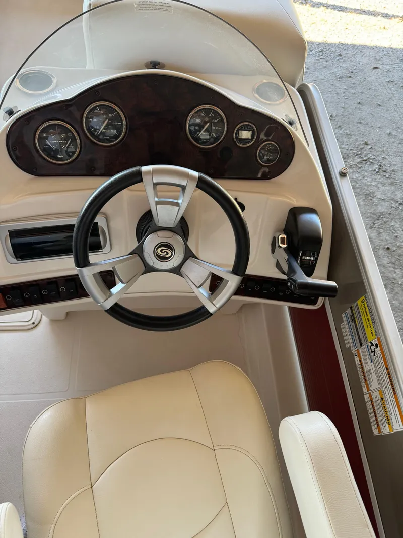 Slide: The Image of 2015 Hurricane Fun Deck 196 boat dashboard with steering wheel and gauges. - 4