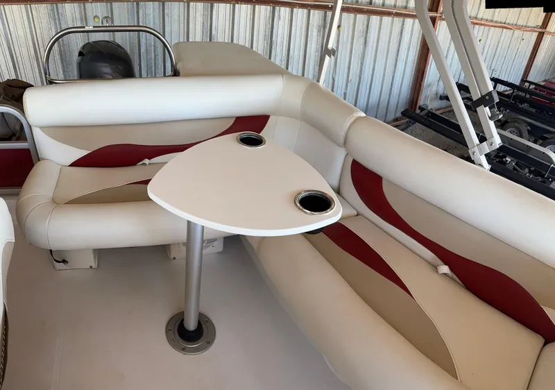 Slide: The Image of 2015 Hurricane Fun Deck 196 interior with white and red seating and table. - 7