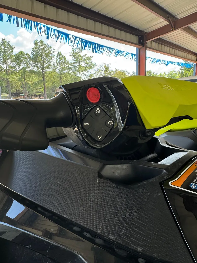 Slide: The Image of Close-up of 2021 Sea-Doo Wake Pro 230 handlebar controls under a canopy. - 3