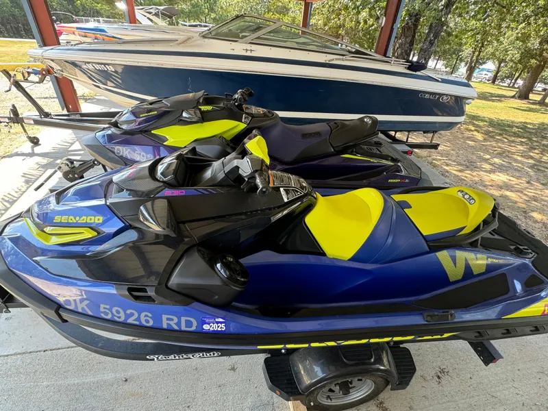 Slide: The Image of 2021 Sea-Doo Wake Pro 230 jet skis in vibrant blue and yellow, parked on a trailer. - 7
