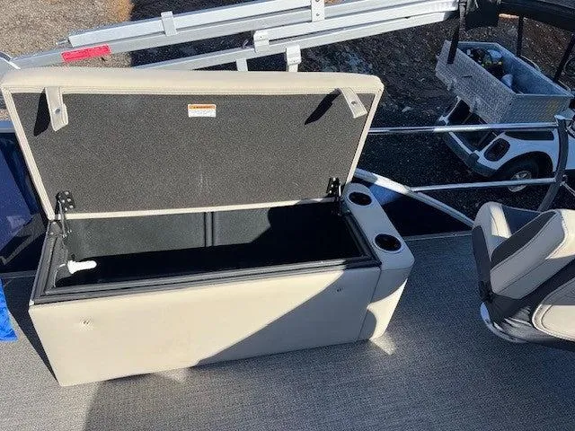 Slide: The Image of 2023 Barletta Cabrio 22CC boat with open storage compartment and seating area. - 6