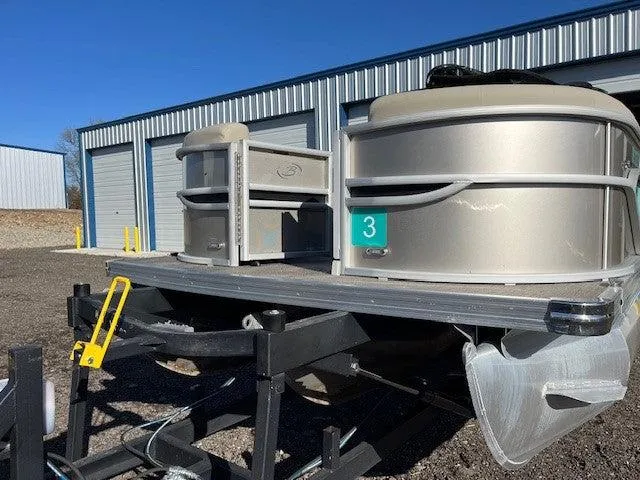 Slide: The Image of 2023 Barletta Cabrio 22UC pontoon boat on trailer, parked outside storage facility. - 3