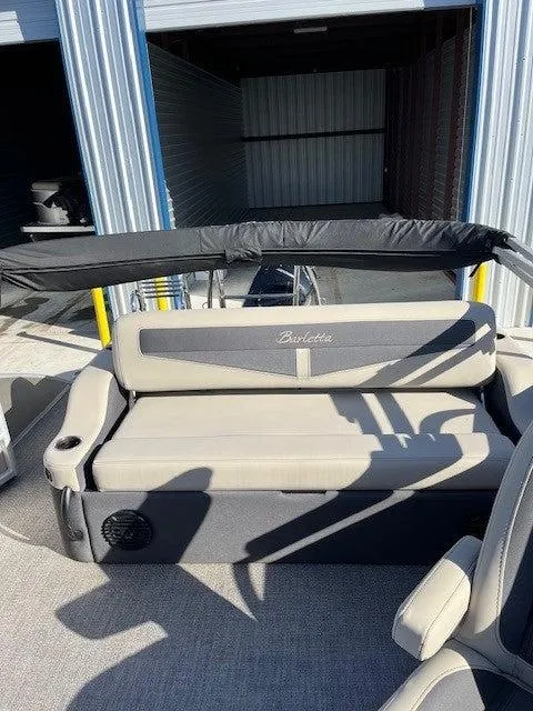Slide: The Image of 2023 Barletta Cabrio 22UC boat interior with cushioned seating and storage. - 6