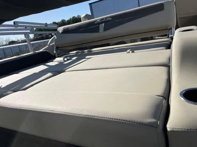 Slide: The Image of 2023 Barletta Cabrio 22UC boat interior with beige seating and cup holder. - 7