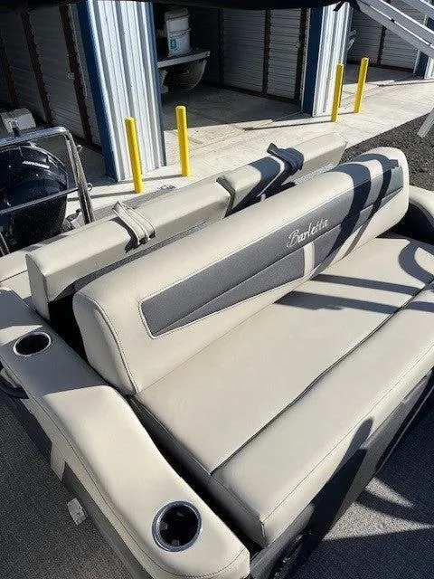Slide: The Image of 2023 Barletta Cabrio 22UC boat with beige seating and cup holders. - 9