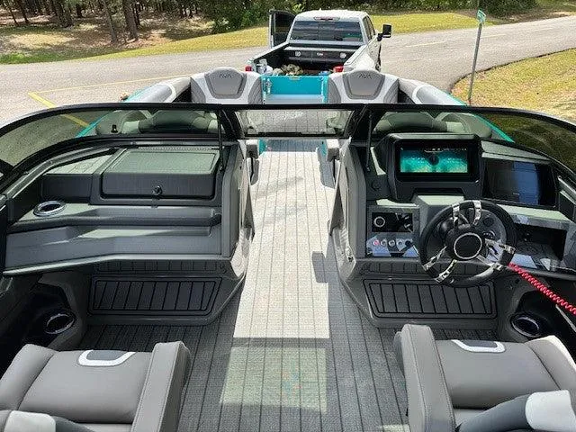 Slide: The Image of 2024 Avalon Quad Lounge Windshield interior with modern dashboard and seating, parked near a road. - 4