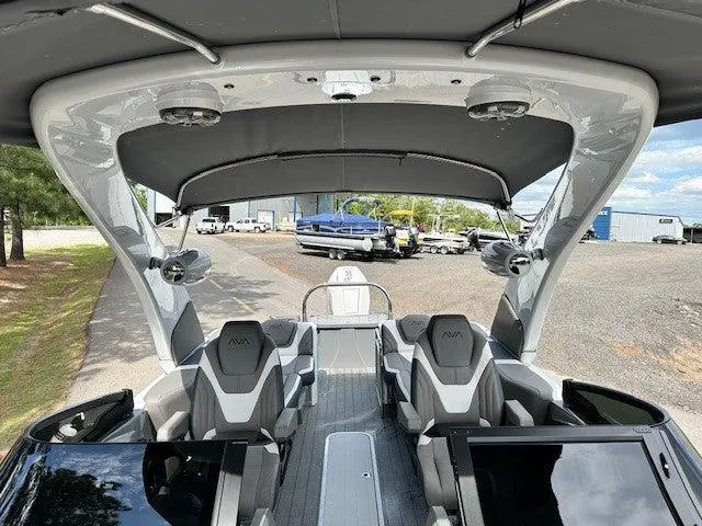 Slide: The Image of 2024 Avalon Quad Lounge Windshield boat interior with modern seating and sleek design. - 7