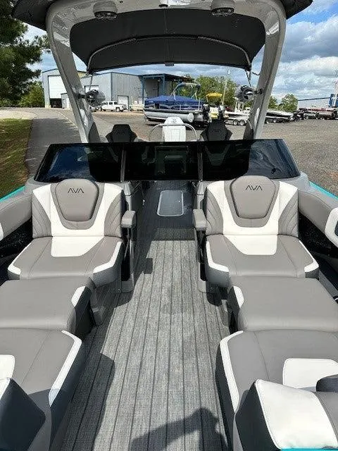 Slide: The Image of 2024 Avalon Quad Lounge Windshield boat with spacious seating and modern design. - 8