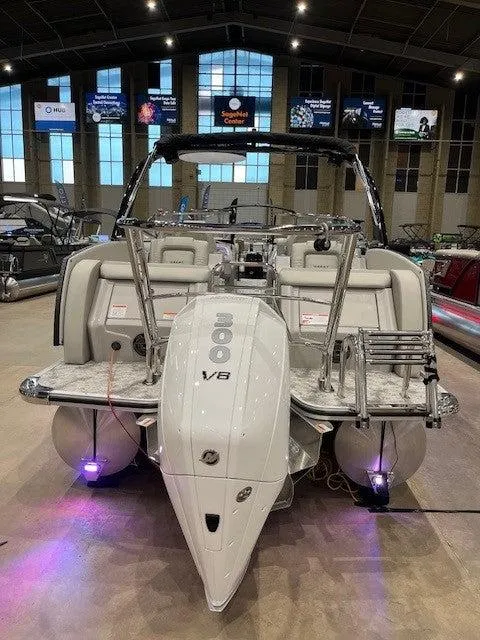 Slide: The Image of 2024 Crest Continental 250 SLRC boat with powerful V8 engine displayed indoors. - 2