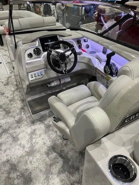 Slide: The Image of 2024 Crest Continental 250 SLRC boat interior with modern helm and luxurious seating. - 4