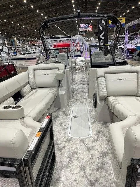 Slide: The Image of 2024 Crest Continental 250 SLRC luxury pontoon boat interior at a boat show. - 6