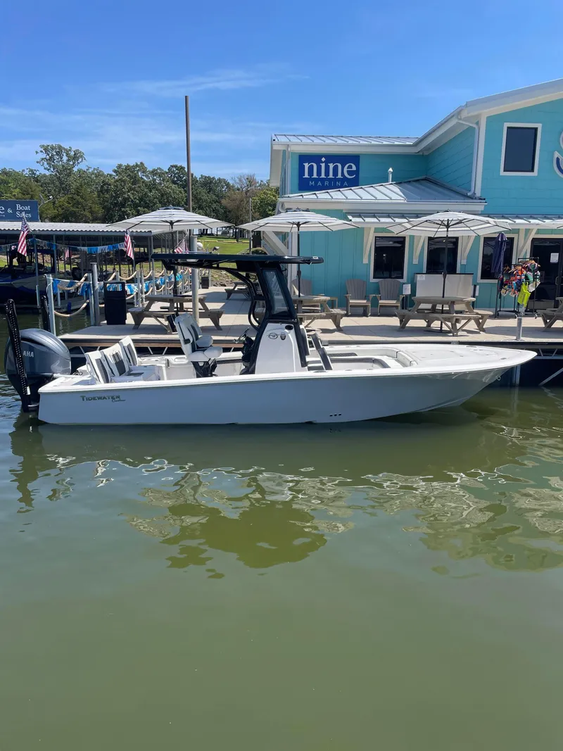 Slide: The Image of 2025 Tidewater Carolina Bay boat docked at marina with blue building in background. - 1