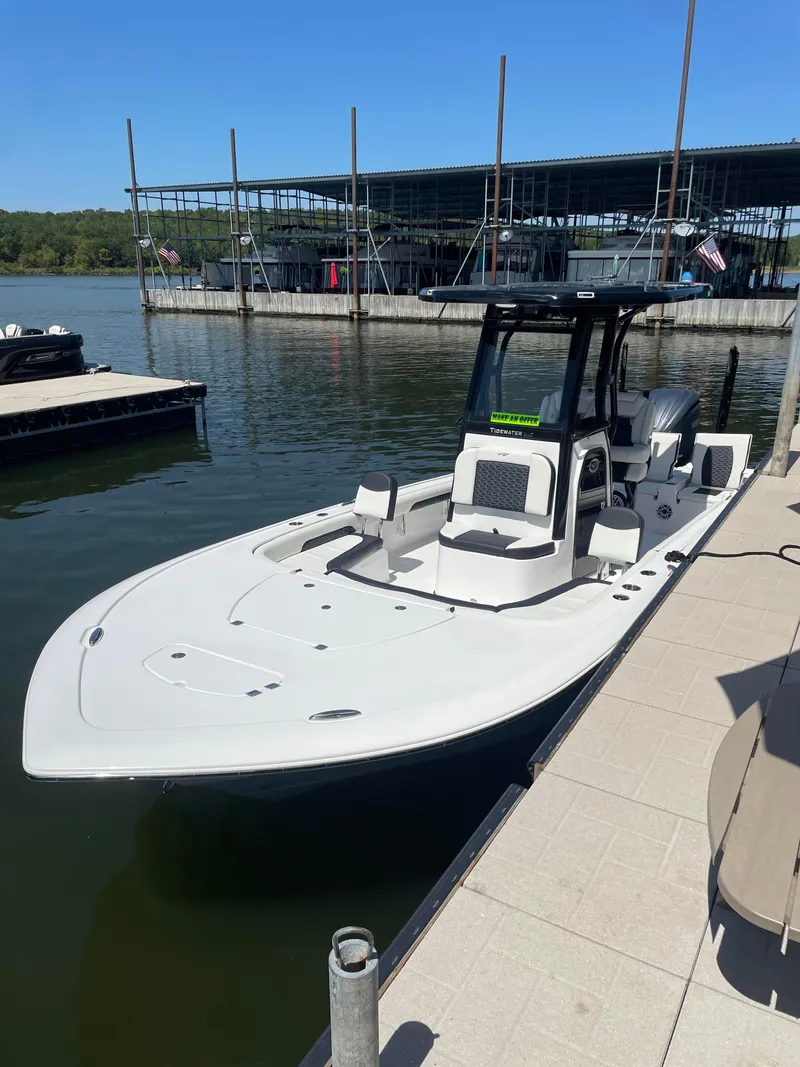 Slide: The Image of 2025 Tidewater Carolina Bay boat docked at a marina under clear blue skies. - 2