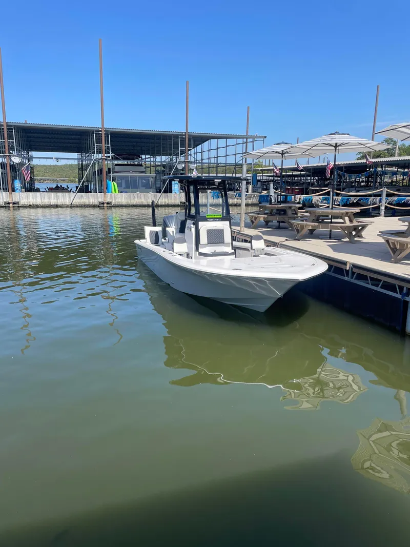 Slide: The Image of 2025 Tidewater Carolina Bay boat docked at a marina under clear blue skies. - 5