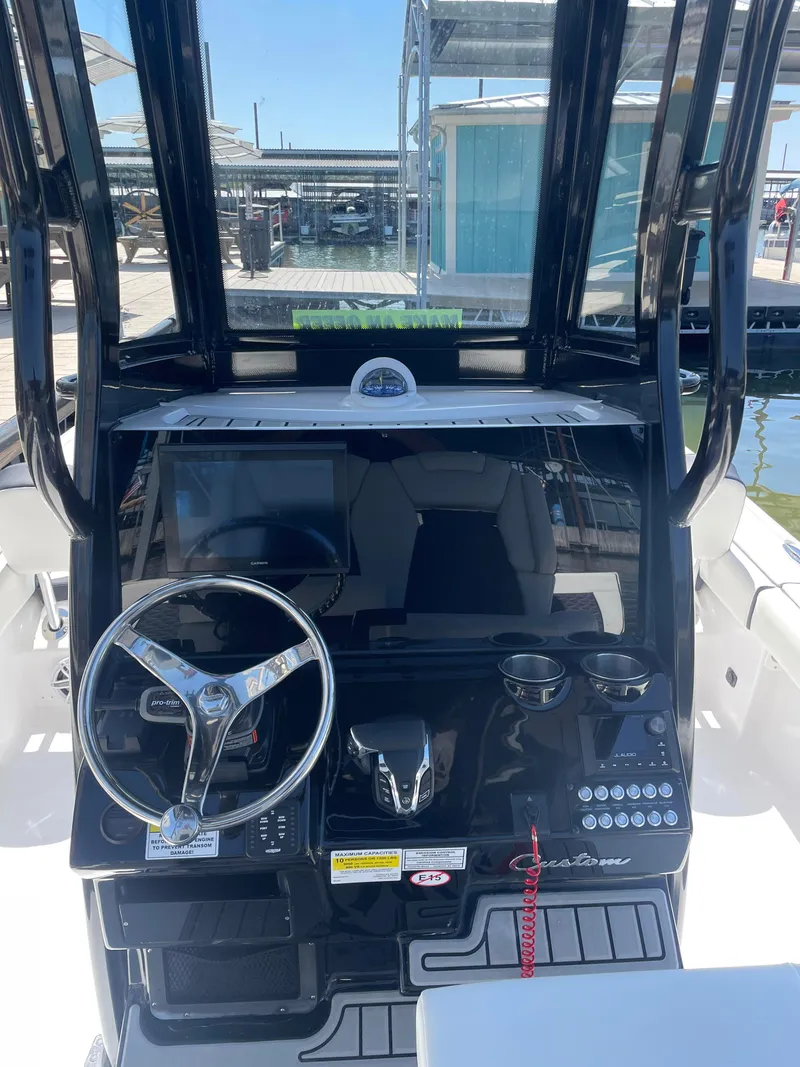 Slide: The Image of 2025 Tidewater Carolina Bay boat dashboard with steering wheel and control panel. - 6