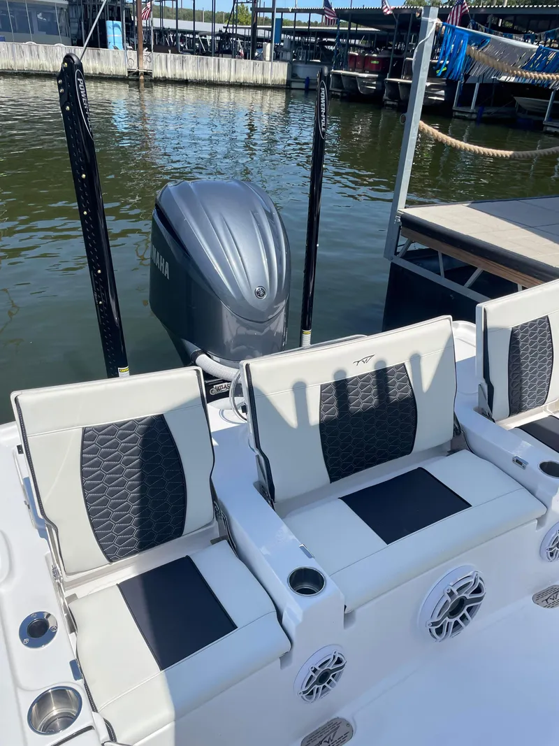 Slide: The Image of 2025 Tidewater Carolina Bay boat with Yamaha engine, docked, featuring stylish seating and speakers. - 8