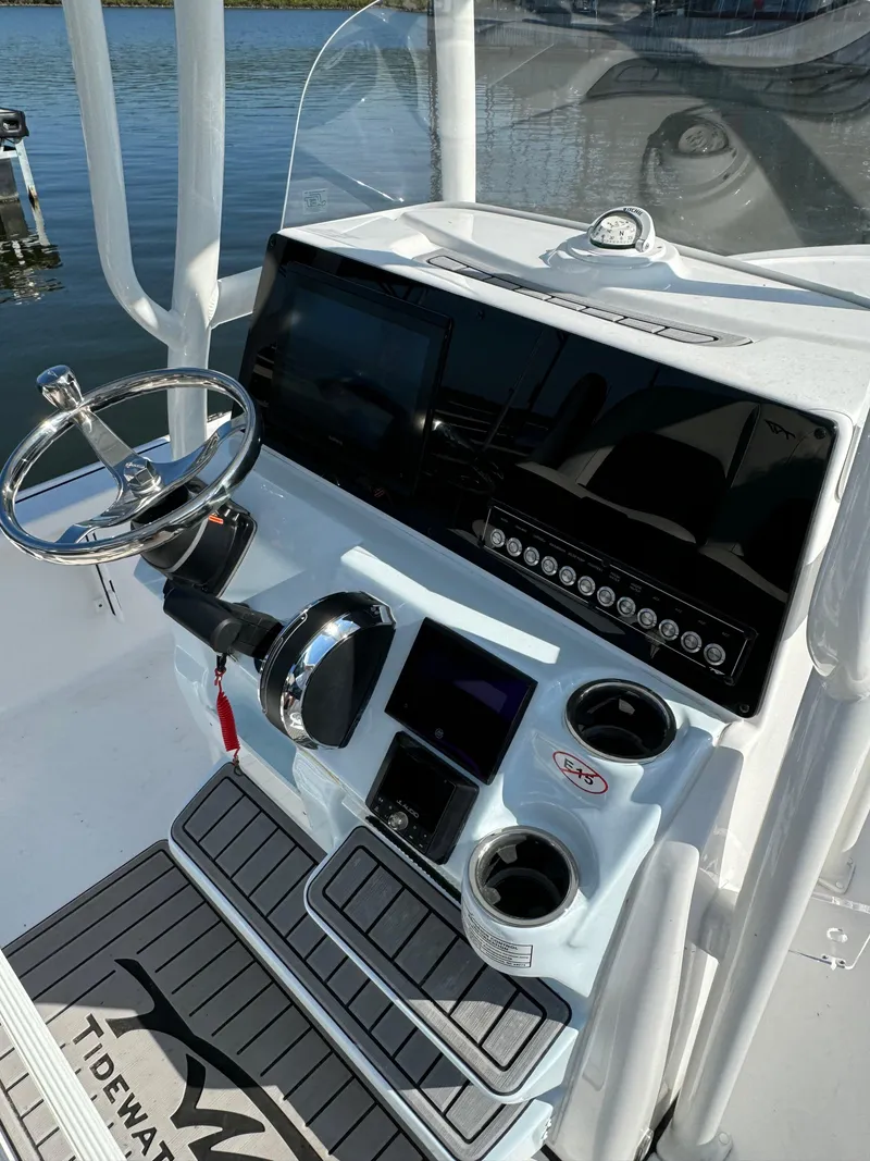 Slide: The Image of 2025 Tidewater 2110 Bay Max boat console with steering wheel and controls. - 4
