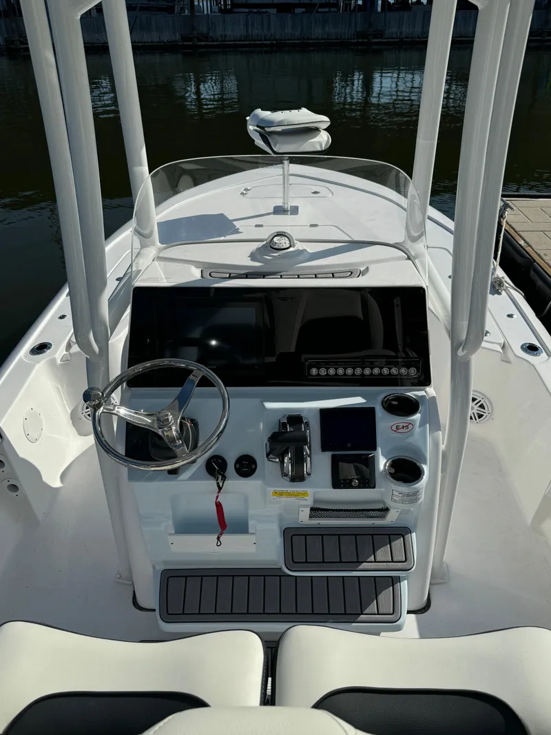 Slide: The Image of 2025 Tidewater 2110 Bay Max boat console with steering wheel and controls. - 5