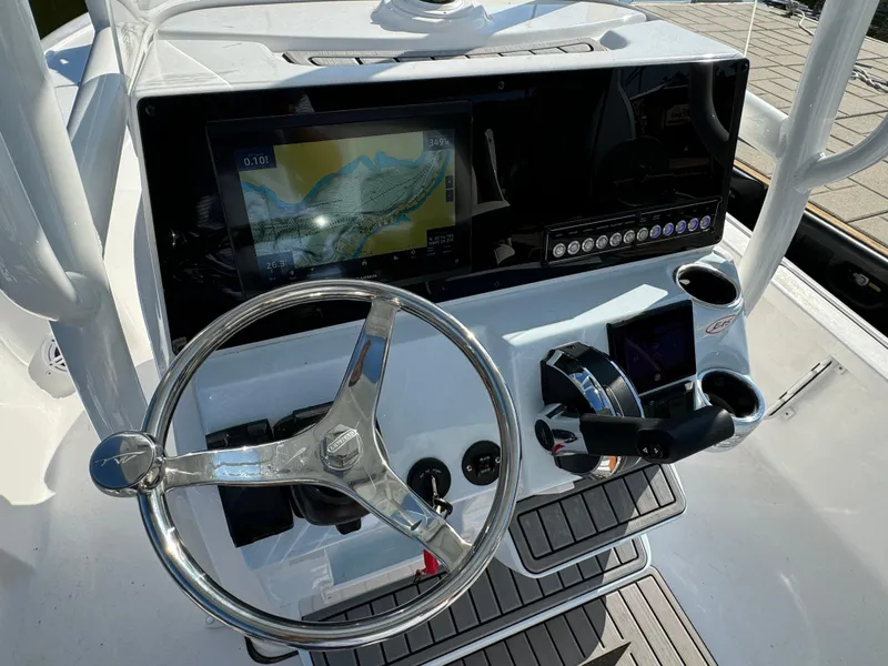Slide: The Image of 2025 Tidewater 2110 Bay Max boat console with steering wheel and navigation display. - 7