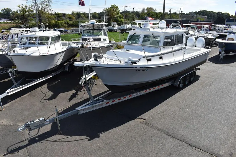 Slide: The Image of 2023 Steiger Craft 31 Miami boat on trailer in marina. - 3