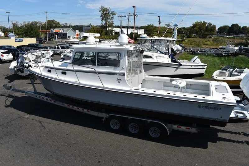 Slide: The Image of 2023 Steiger Craft 31 Miami boat on trailer in marina setting. - 4