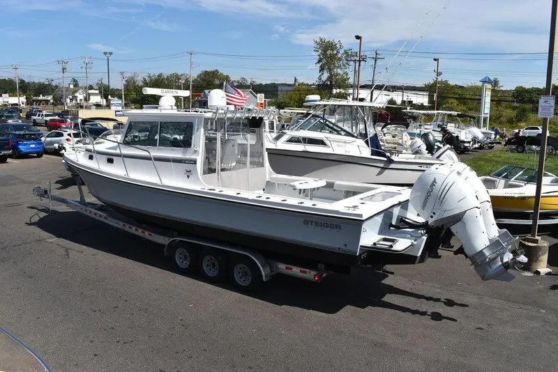Slide: The Image of 2023 Steiger Craft 31 Miami boat on trailer in marina parking lot. - 6