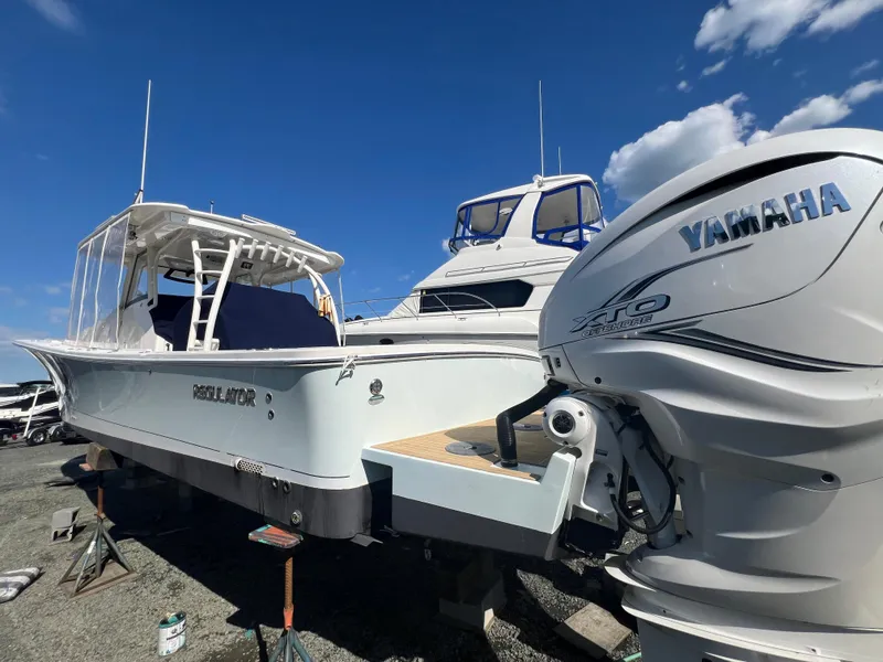 Slide: The Image of 2019 Regulator 41 boat with Yamaha engine, docked under clear blue sky. - 12