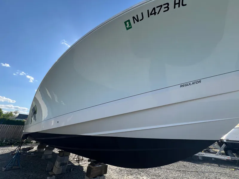 Slide: The Image of 2019 Regulator 41 boat on stands, side view, with NJ registration. - 15